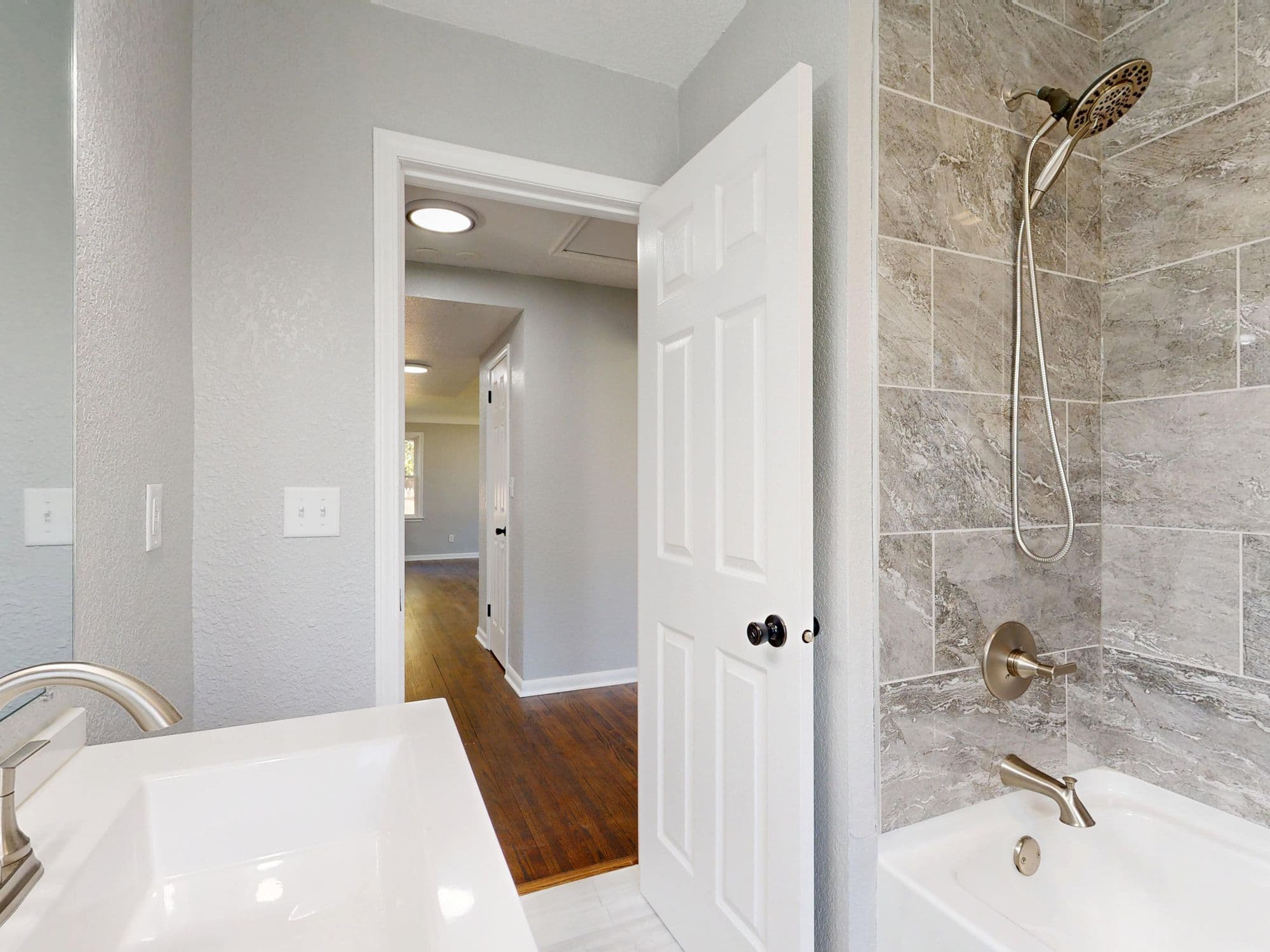 A remodelled bathroom with a tiled shower and brushed fixtures